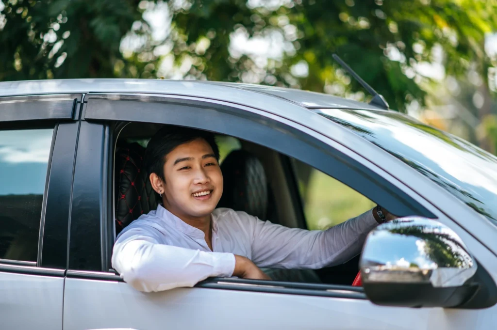 24-hour car tyre, A happy asian man in his car after tyre repair